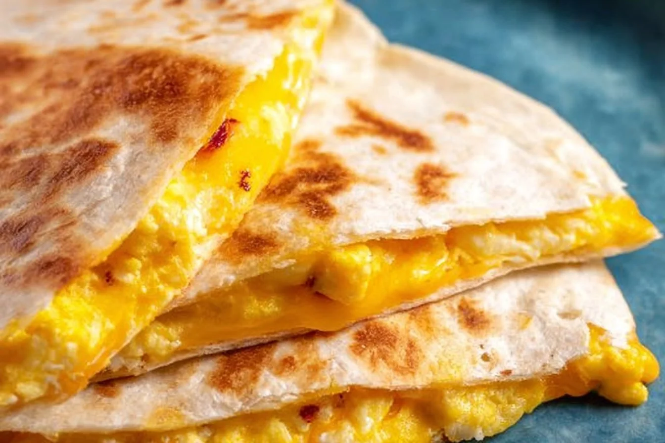 Breakfast Quesadillas 5 Delicious breakfast quesadillas filled with eggs and cheese on a plate.