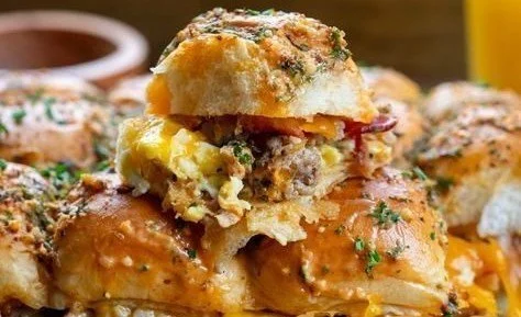 Delicious Cowboy Breakfast Sliders loaded with eggs, bacon, and cheese for a tasty meal.