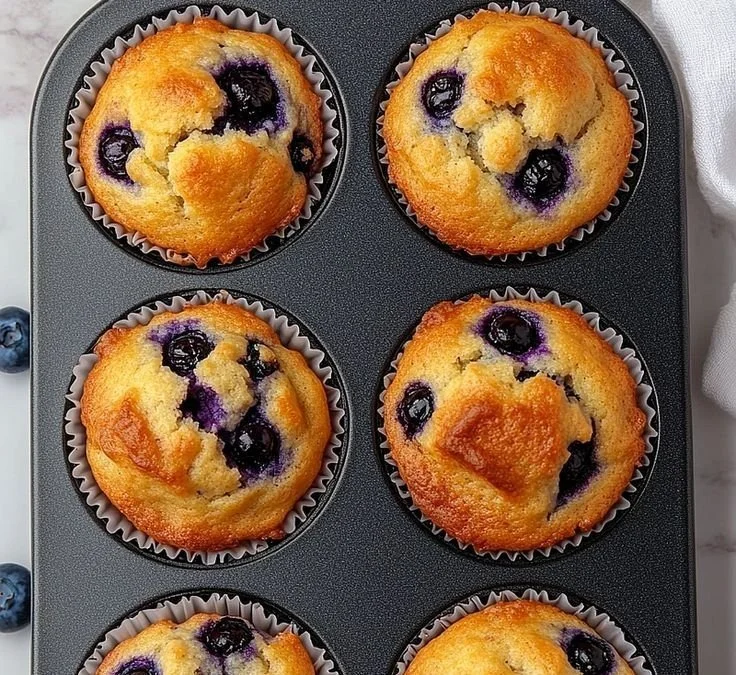 Hearty blueberry protein muffins on a wooden table