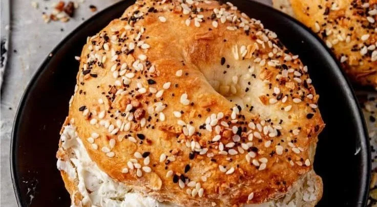 High-protein cottage cheese bagel topped with fresh herbs and vegetables