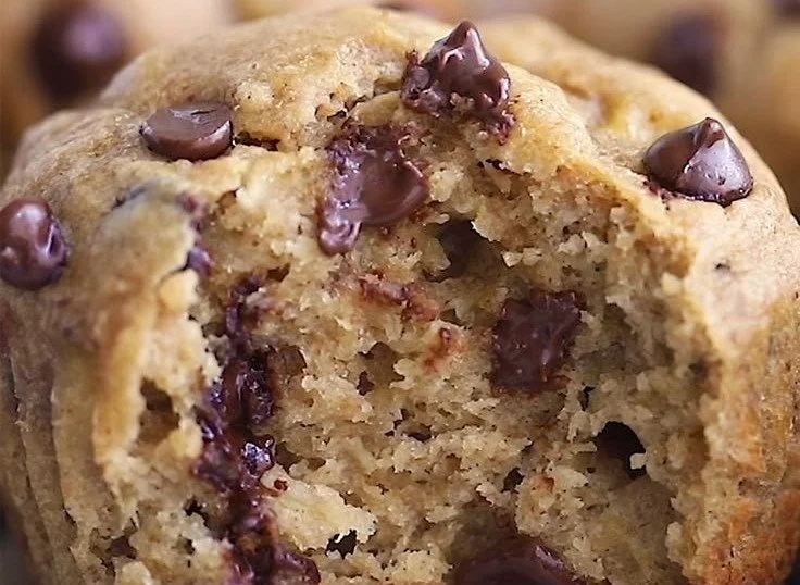 Freshly baked Peanut Butter Banana Muffins on a wooden table