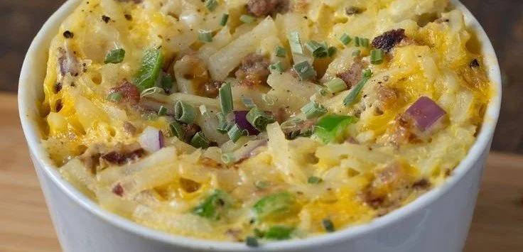 Delicious microwave breakfast bowl filled with scrambled eggs, spinach, and cheese.