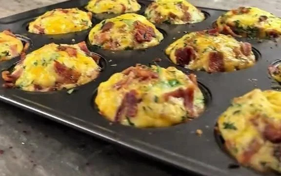 Delicious loaded egg bites with cheese, veggies, and spices